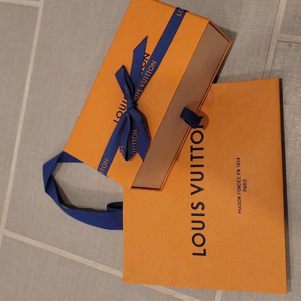Louis Vuitton sunglasses box and small shopping bag.
